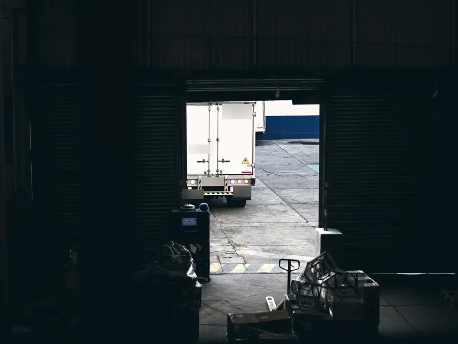 A truck waiting at a warehouse loading dock